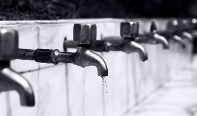 A black and white photo of faucets