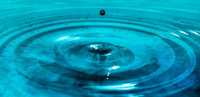 A drop of water and ripples on a body of water