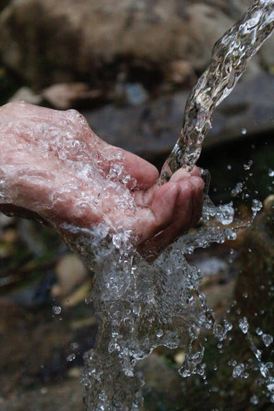 A man washing his hand in water